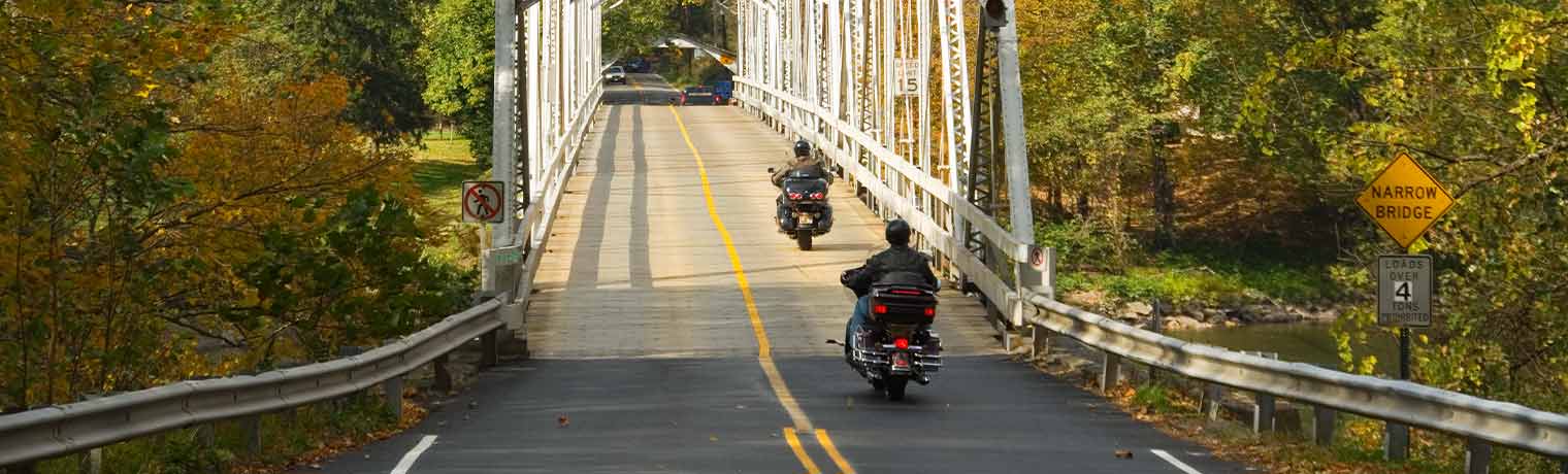 New Jersey motorcyclists approaching a wooden bridge