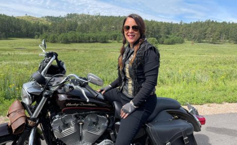 Photo of Dawn Givesi sitting on a motorcycle